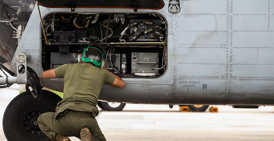 Image of technician working on military aircraft